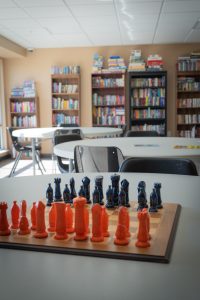 Library books and chess board game